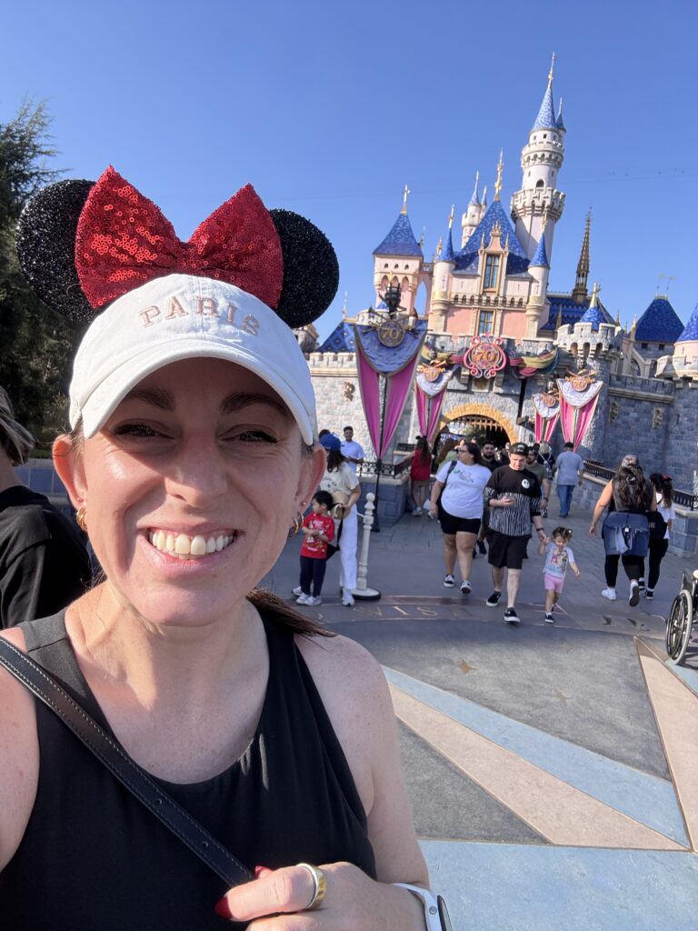 JCA team member at Disneyland's Sleeping Beauty Castle during KindCon 2025