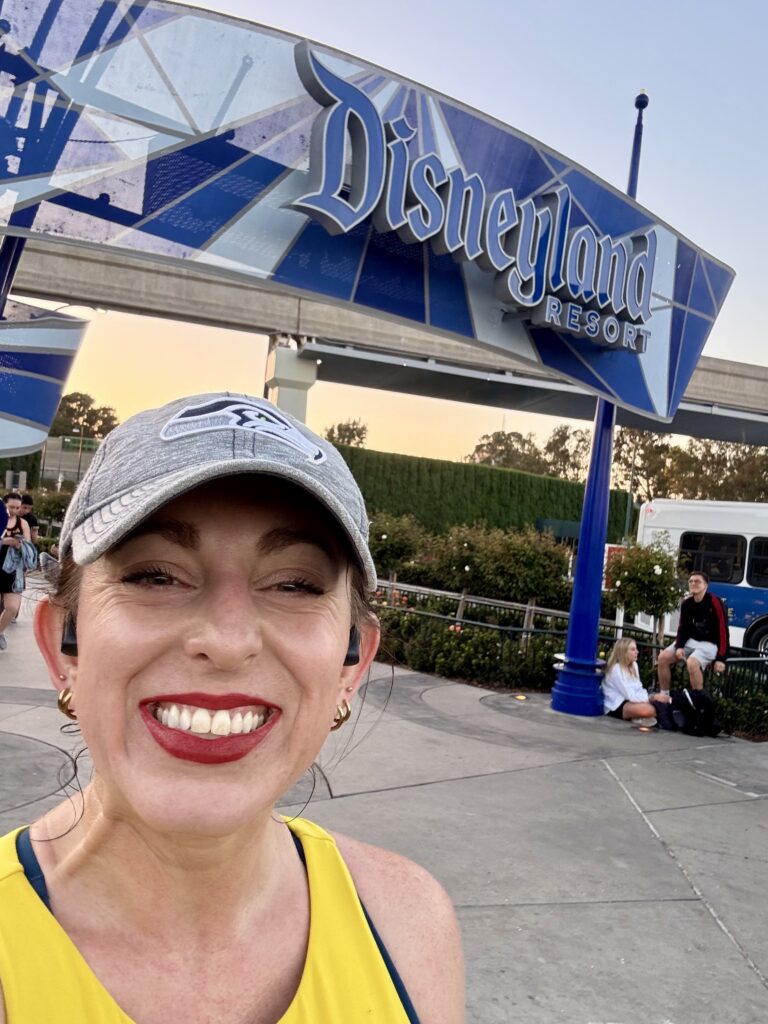 JCA team member at Disneyland Resort entrance near KindCon 2025 venue in Anaheim